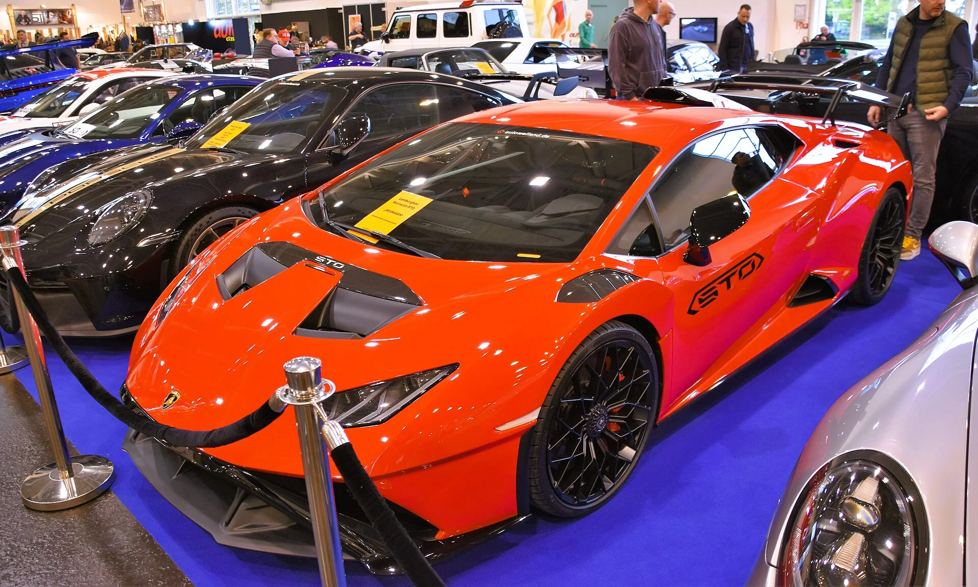 Orange Lamborghini Huracán STO presented in an elevated three-quarter view