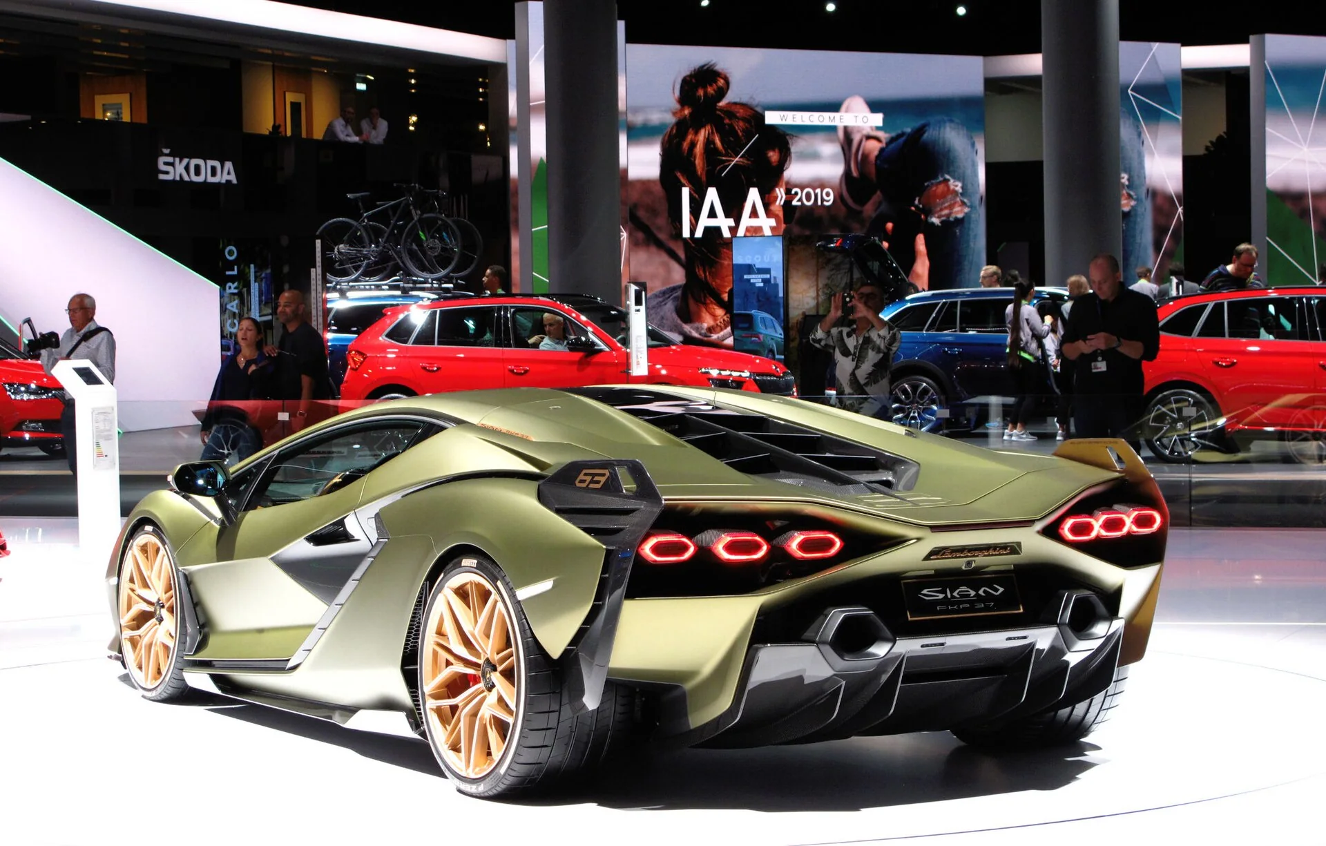 Green Lamborghini Sián FKP 37 in a rear three-quarter exhibition view